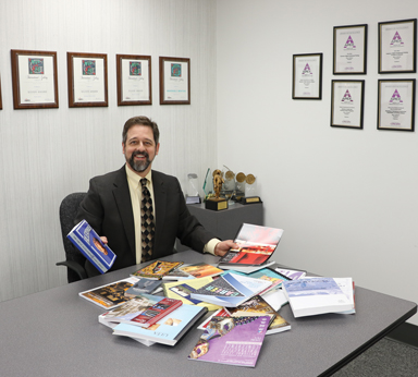 Copresco President Steve Johnson shows off clients' digital books and publications.